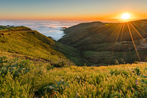 Sunrise photo of California hills and rolling fog coming in.