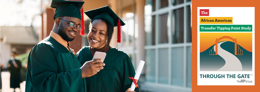 2 students in graduation regalia smiling and taking a selfie